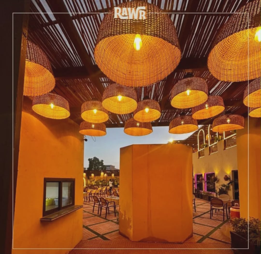 Rawr Cafe outdoor seating under large wicker dome lamps at dusk